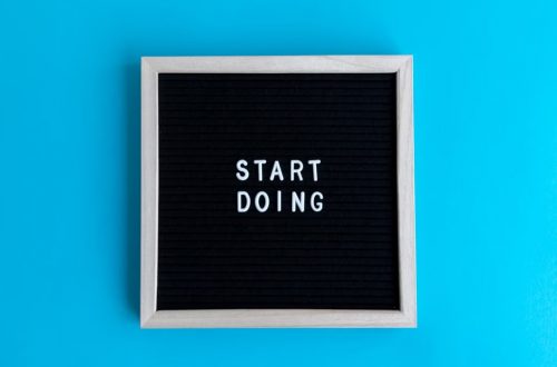 Black letter board with 'START DOING' text on a vibrant blue background.